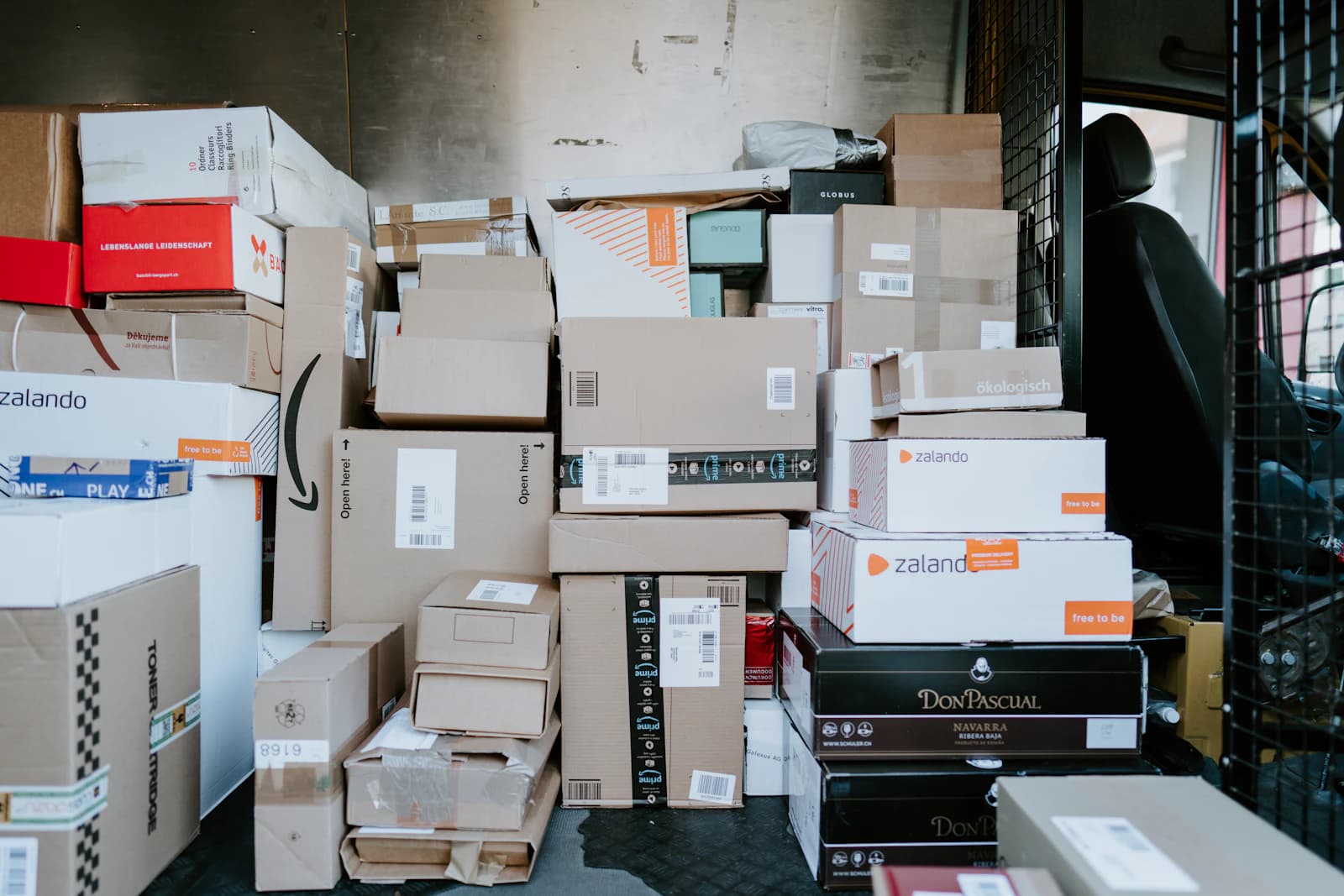 Cardboard parcels stacked in the back of a delivery van
